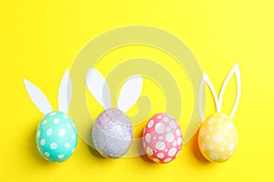 Nest with ÃÂolorful easter eggs, flowers and feathers on wooden background